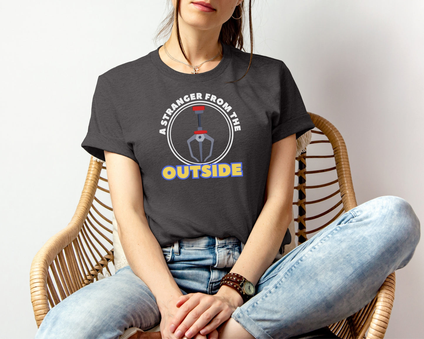 female model wearing bella and canvas 3001 t-shirt in dark grey heather with 'a stranger from the outside' grabber claw graphic on chest inspired by Toy Story