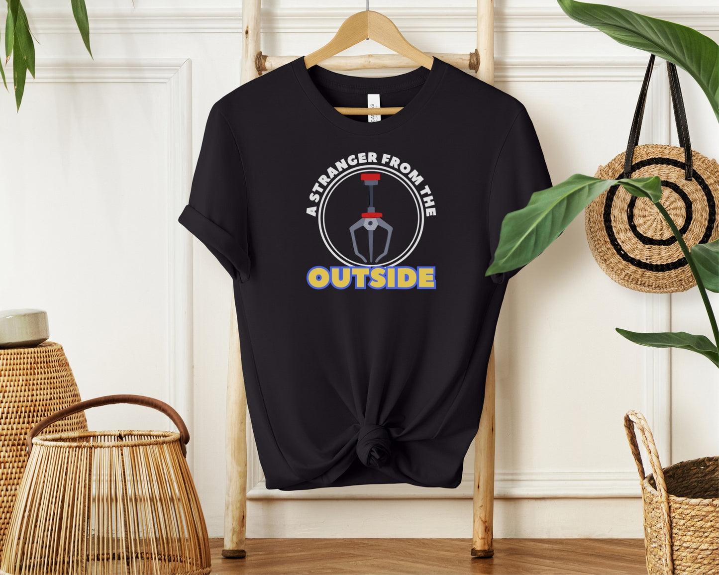 hanging bella and canvas 3001 t-shirt in black with 'a stranger from the outside' grabber claw graphic on chest inspired by Toy Story