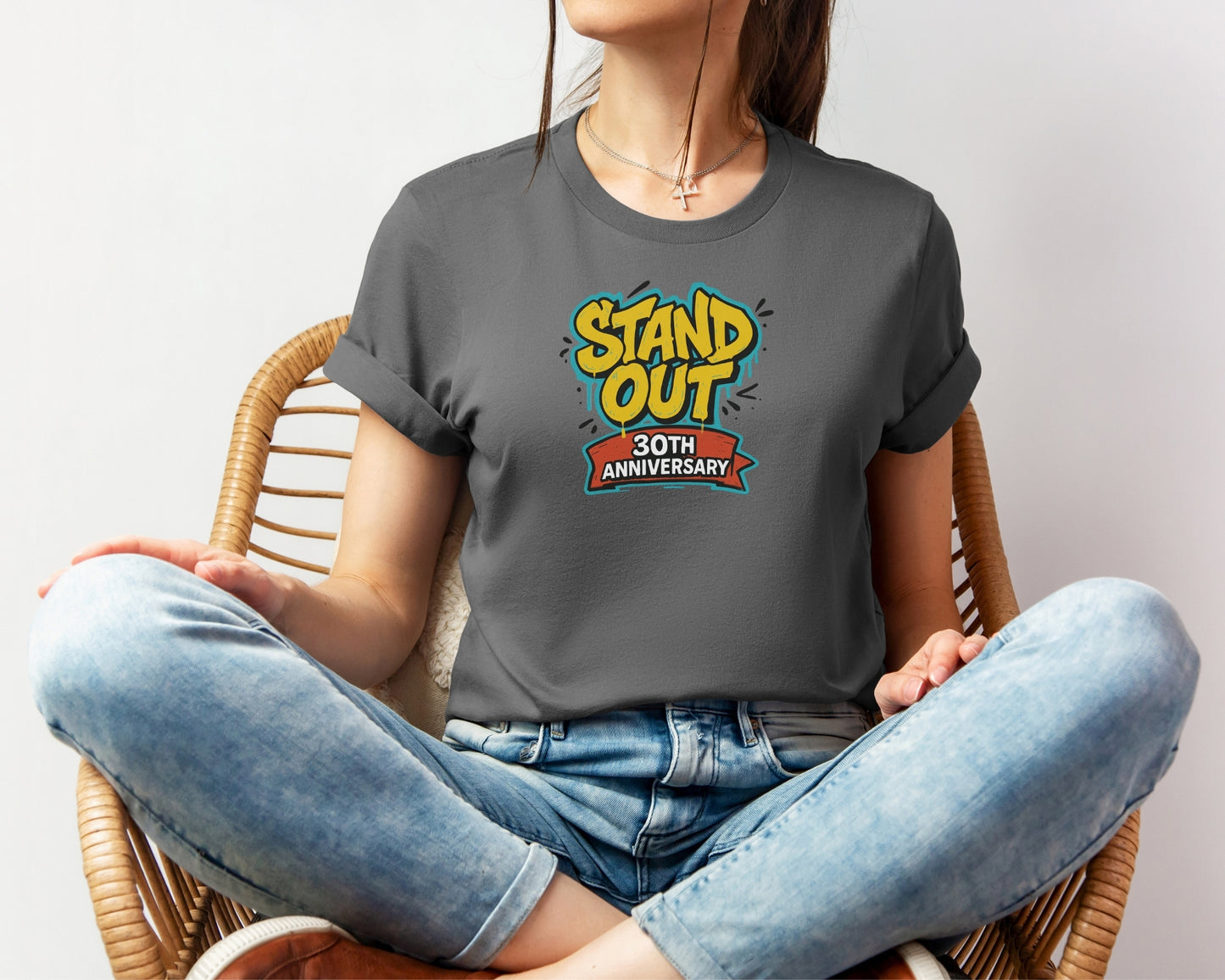 Female model wearing Bella and Canvas 3001 t-shirt in heather asphalt, with a Disney inspired 'stand out 30th anniversary' print on chest to celebrate the A Goofy Movie 30th anniversary
