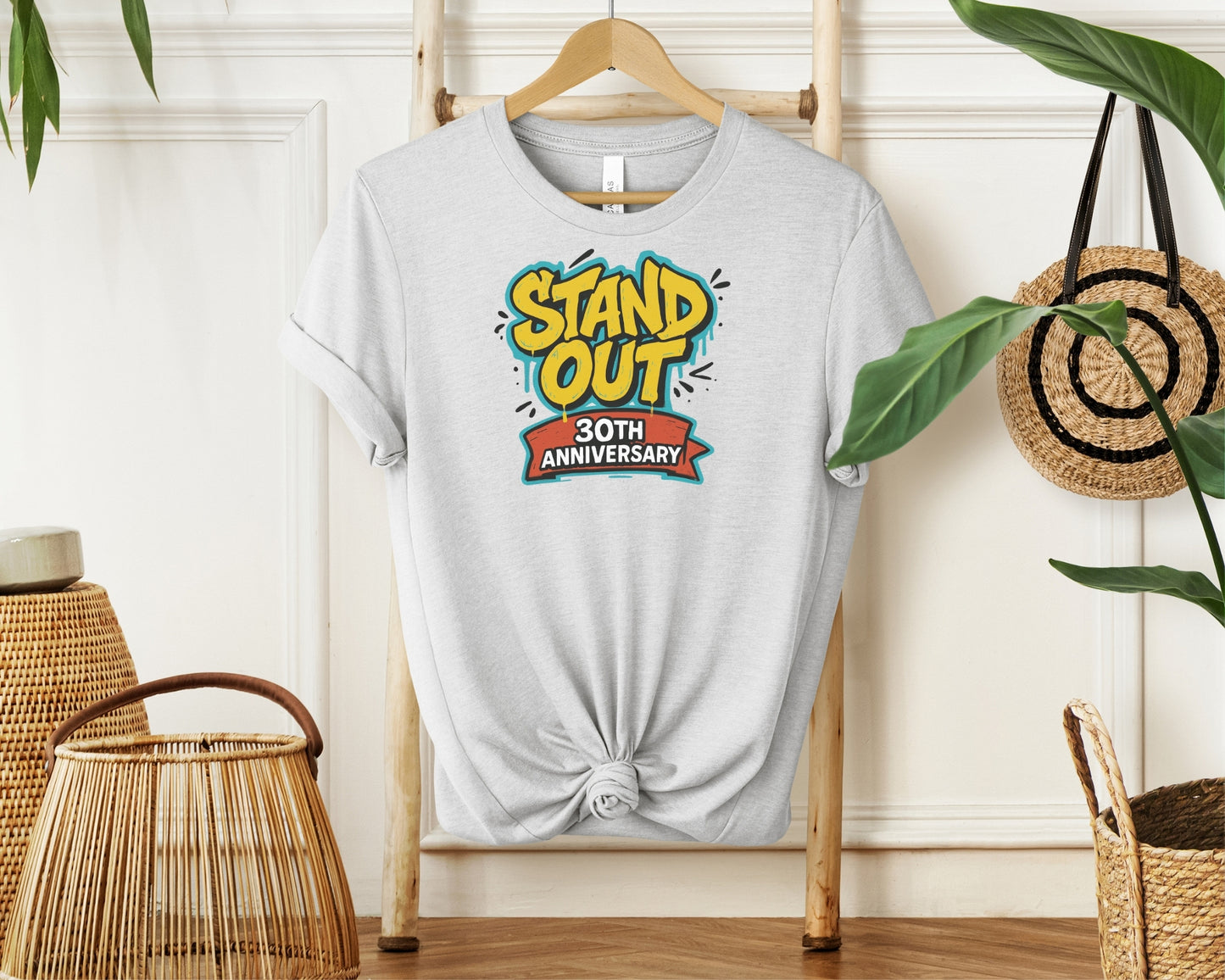 hanging Bella and Canvas 3001 t-shirt in ash, with a Disney inspired 'stand out 30th anniversary' print on chest to celebrate the A Goofy Movie 30th anniversary