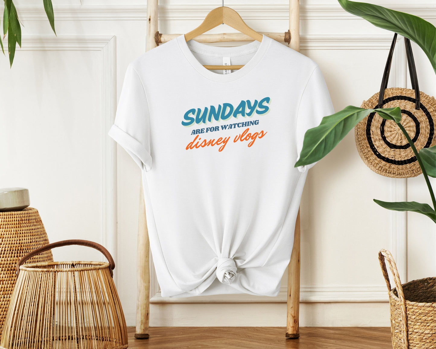 hanging bella and canvas 3001 in white with 'sundays are for watching Disney vlogs' print on chest inspired by Disney YouTube