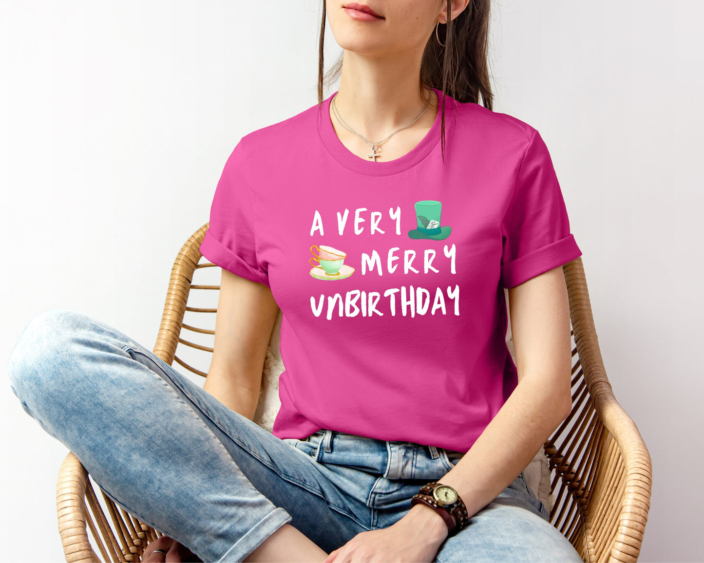 Female model wearing Bella and Canvas 3001 T-Shirt in berry, with a disney/Alice in Wonderland inspired 'a very merry unbirthday' design on chest