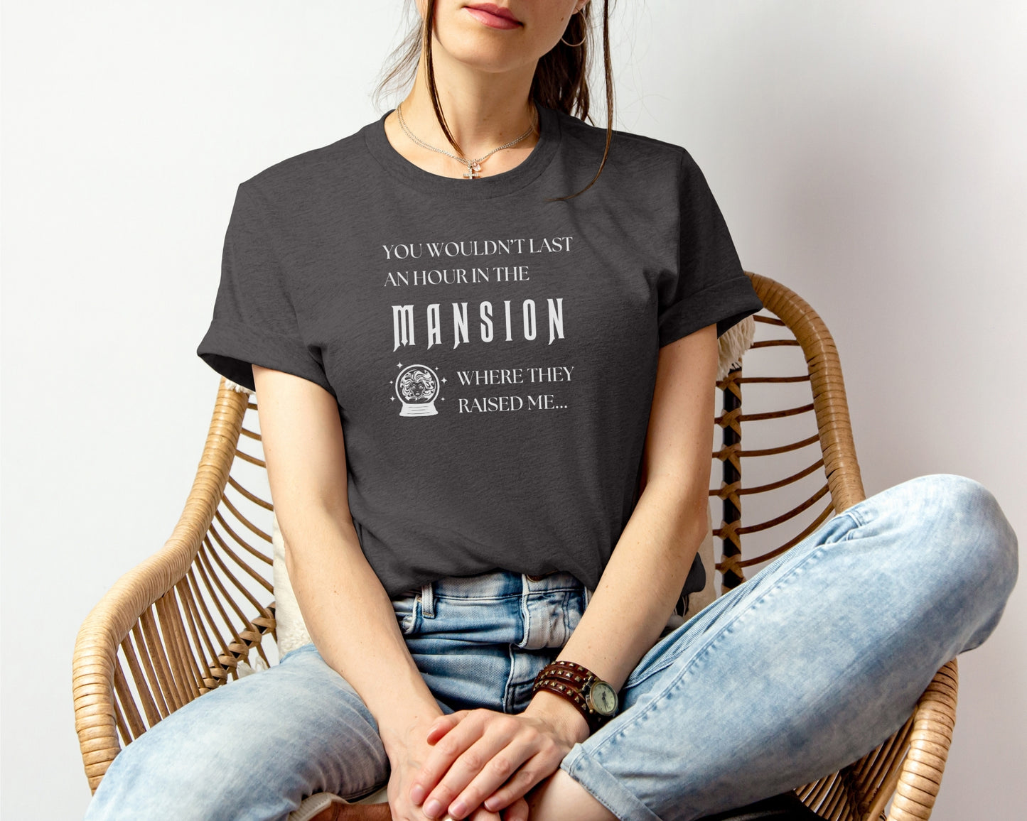 female model wearing bella and canvas 3001 t-shirt in dark grey heather with 'you wouldn't last an hour in the mansion where they raised me' on chest, TTPD taylor swift x haunted mansion inspired design 