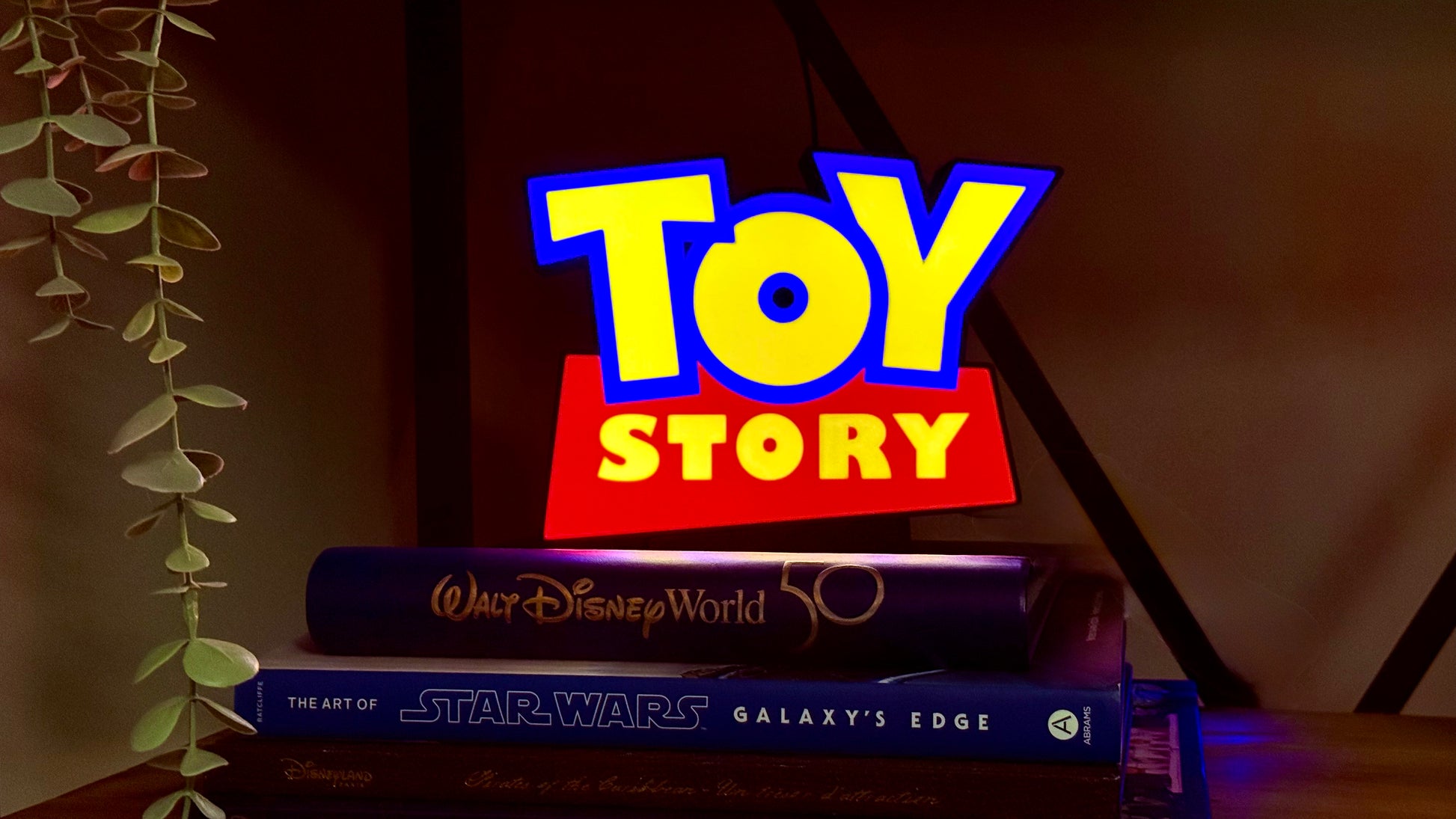 Toy Story inspired LED light box night light glowing on shelf with Pixar style lettering