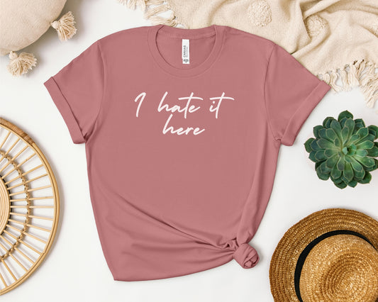Bella and Canvas 3001 t-shirt in mauve laid flat with TTPD lyric design on chest, 'I hate it here' print on chest inspired by Taylor Swift