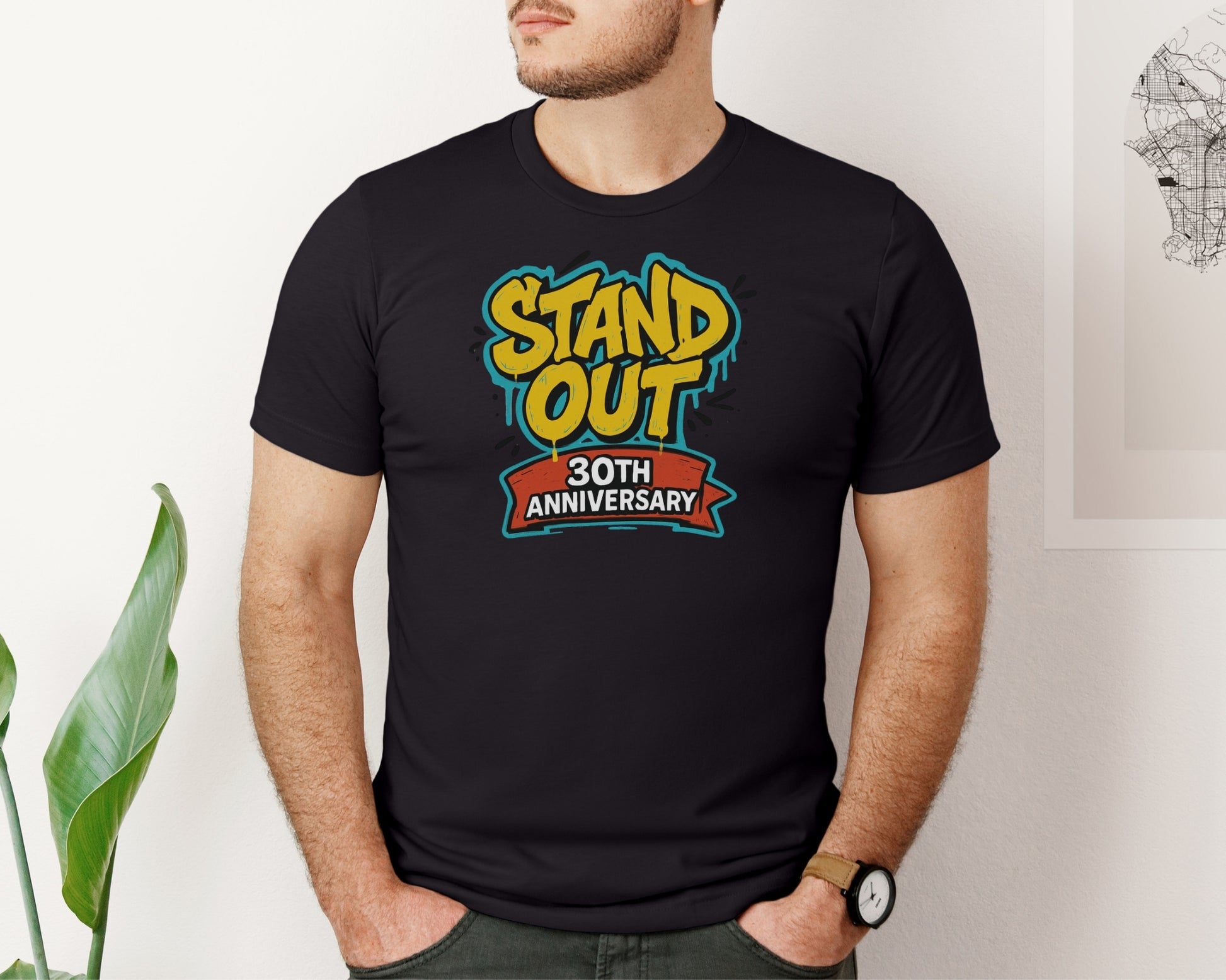 male model wearing Bella and Canvas 3001 t-shirt in black, with a Disney inspired 'stand out 30th anniversary' print on chest to celebrate the A Goofy Movie 30th anniversary 