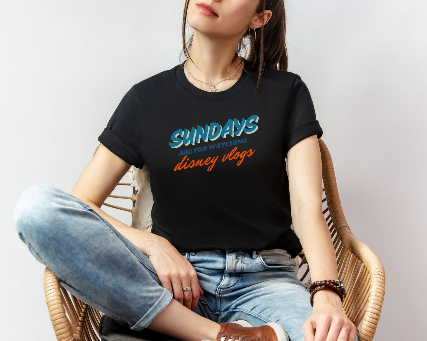 female model wearing bella and canvas 3001 in black with 'sundays are for watching Disney vlogs' print on chest inspired by Disney YouTube